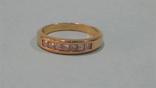 An 18ct gold Princess cut seven stone diamond ring