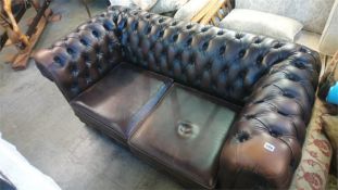 A Chesterfield brown leather two seater settee
