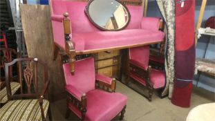 An Edwardian oak three seater settee and a matching pair of armchairs