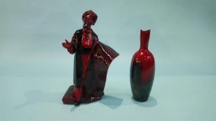 A Royal Doulton flambé figure 'The Carpet Seller', HN 2278 and a flambé vase, HN 1603