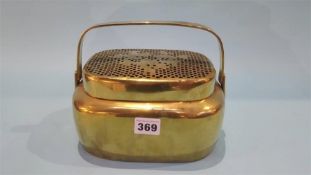 An Oriental lidded brass box, pierced lid with foliage decoration