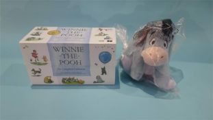 A boxed (unopened) 'Winnie The Pooh', the Complete Collection and an Eeyore soft toy (cost £149.99)