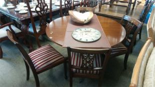 A reproduction circular table and four chairs