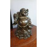 A bronze figure of Buddha. 42cm wide