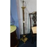 A brass Corinthian column standard lamp and a pair of table lamps