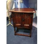 A small oak two door cabinet. 51cm diameter