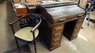 An oak tambour fronted desk and chair