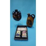 A boxed set of four Royal Doulton floral encrusted napkin rings, a Dewars Whiskey flask and a two