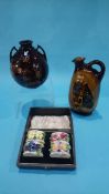 A boxed set of four Royal Doulton floral encrusted napkin rings, a Dewars Whiskey flask and a two