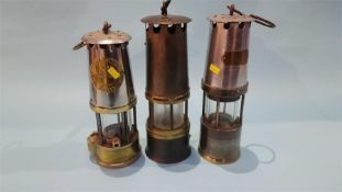 Three miner's lamps, various