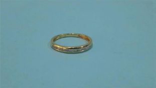 An 18ct gold half hoop eternity ring