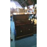 A reproduction mahogany two door cabinet