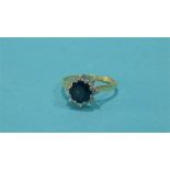 An 18ct gold sapphire and diamond cluster ring, stamped 750