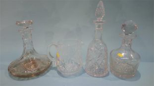 Three glass decanters and a water jug