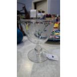 A floral etched wine glass
