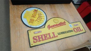 Two cast Shell Oil signs