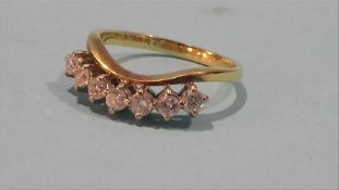 An 18ct gold seven stone diamond half hoop ring