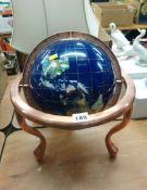 A globe inlaid with semi precious stones