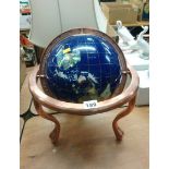 A globe inlaid with semi precious stones