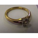 An 18 ct gold solitaire ring with .60 carat diamon