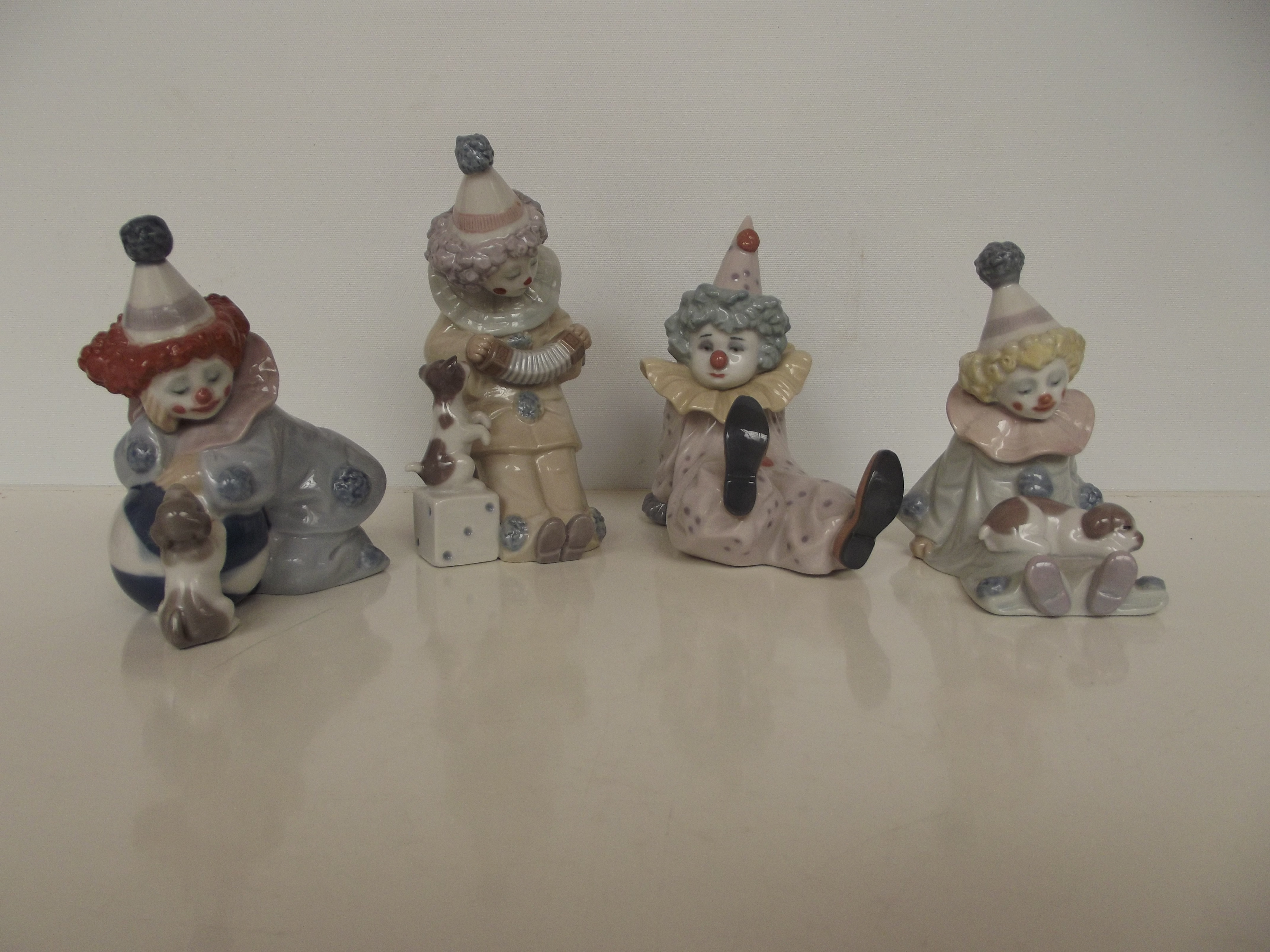 Group of four Lladro clowns, tallest 15cm