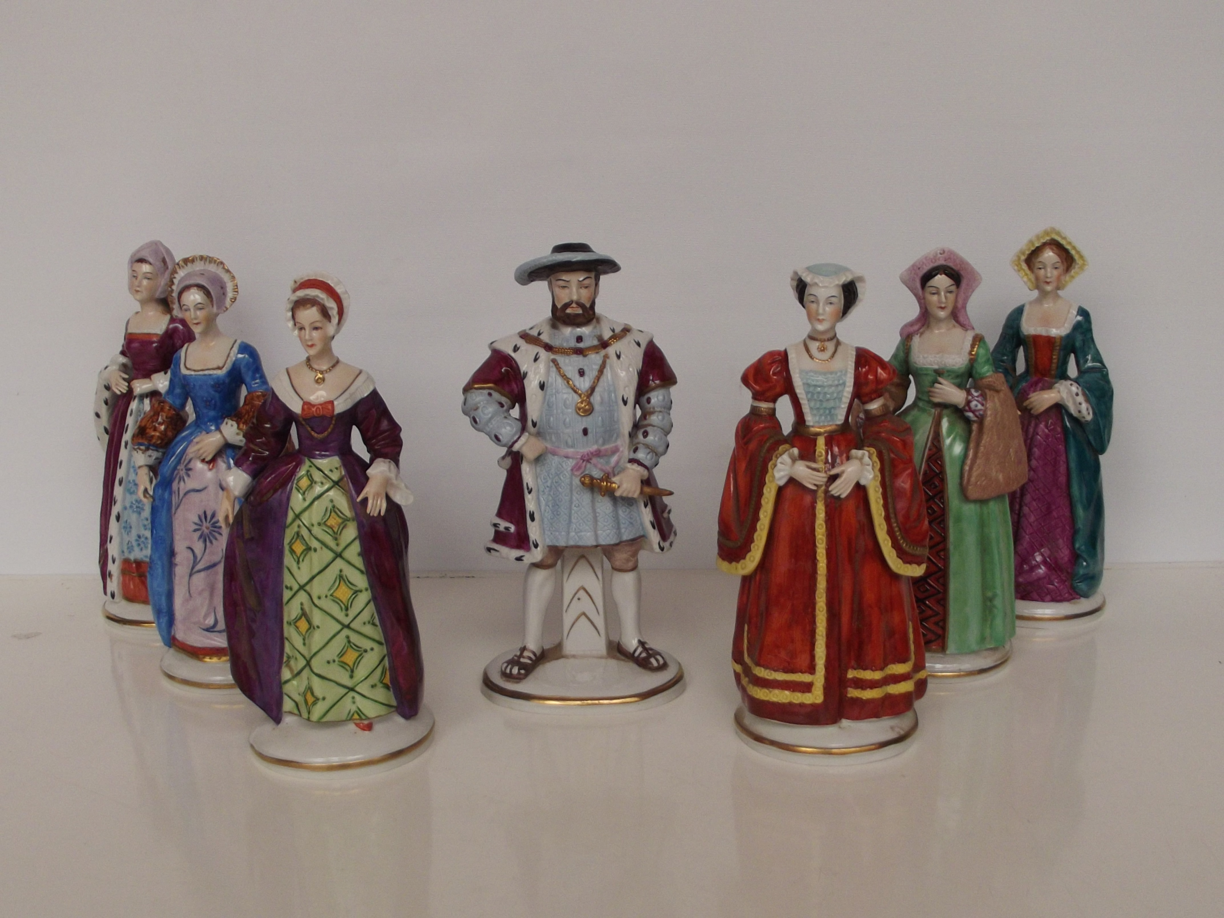 Set of 7 Sitzendorf figures, models as Henry VIII