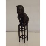 Bronze child on stool