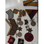 Group of military medals and cloth badges