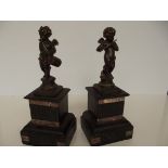 Pair of garniture cherubs on slate bases, a/f