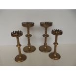 Two pairs of brass gothic candle sticks