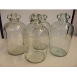 Four demijohn glass bottles