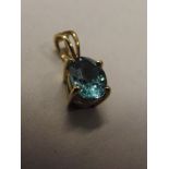 10 carat gold pendant set with blue gemstone