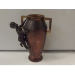 Bronze twin handled vase with cherub