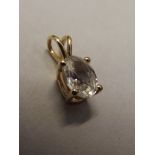 10 carat gold pendant set with white gemstone