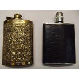 Repoussé hip flask together with a leather hip fla