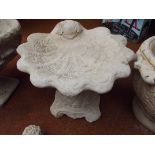 Bird bath in the form of a shell