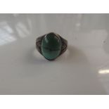 Silver dress ring set with green stone