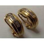 Pair of 18ct gold earrings paved with six square c