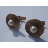 Pair of 14 carat gold cufflinks set with central p
