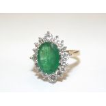 18 carat gold, emerald and diamond ring. An oval c