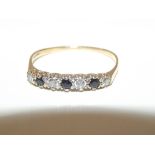 9ct gold ladies ring with four diamonds and 3 blac