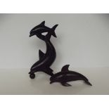 Two wooden dolphin figures