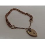 9ct gold bracelet with a heart locket and safety c