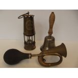 Brass car horn, a miners lamp and a school bell