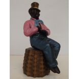 Afro American figure taking snuff