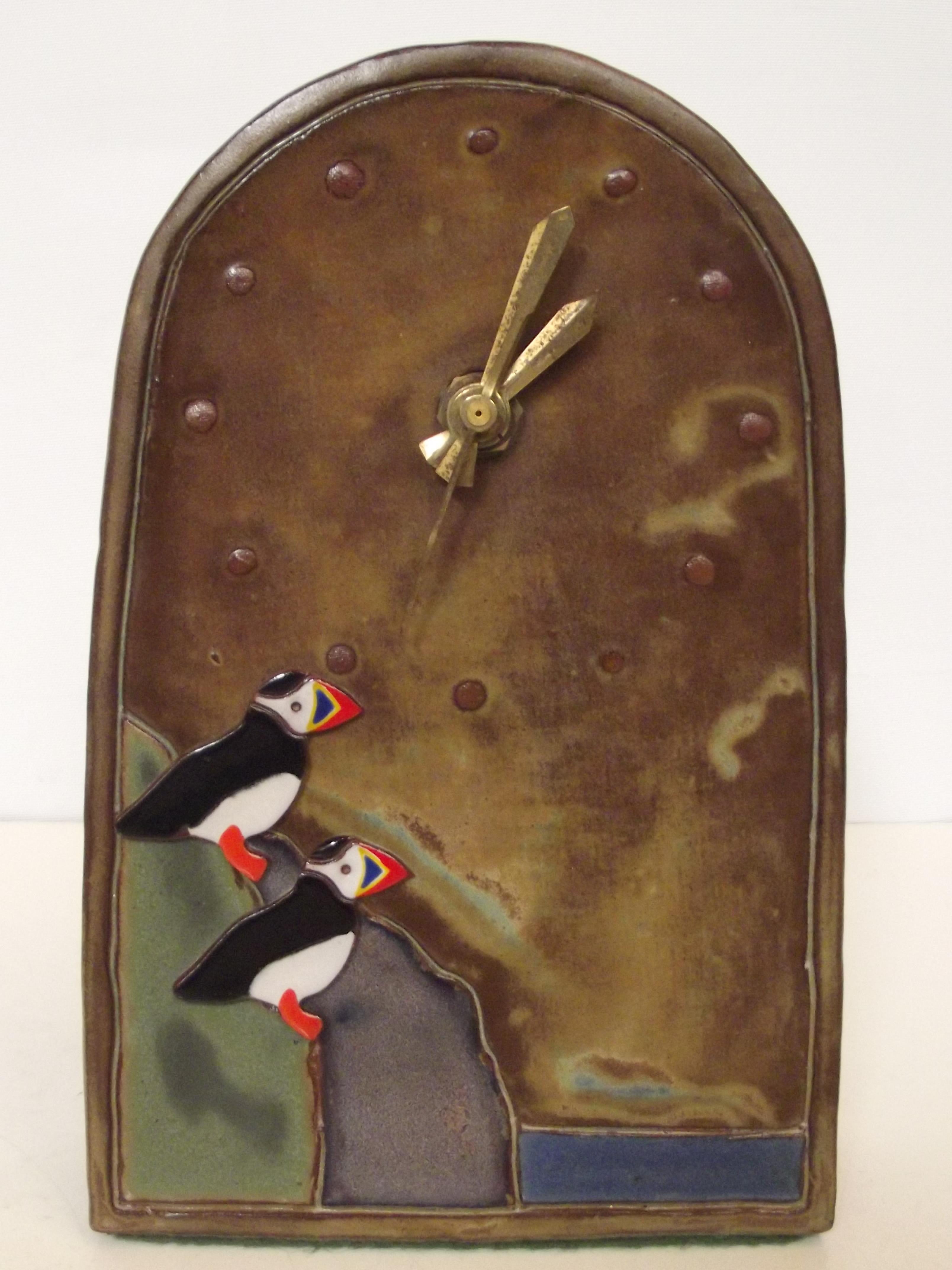 Studio pottery clock depicting two Atlantic puffin