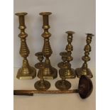 Three pairs of brass candlesticks together with a