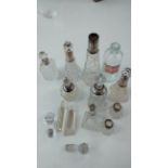 Collection of silver rimmed perfume bottles and ot