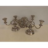 Three matching silver plated two branch candelabra