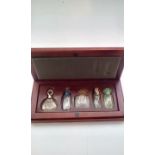 Cased set of five scent bottles, one being Lalique